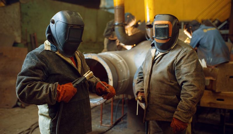 two-welder-in-masks-prepares-to-work-with-metal-KTPAD5L two-welder-in-masks-prepares-to-work-with-metal-KTPAD5L